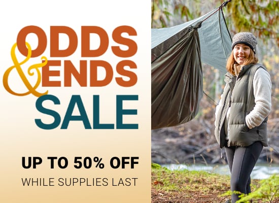 Odds & Ends Sale banner, up to 50% off while supplies last. Picture of a woman setting up a hammock by the river.